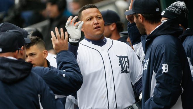 Tigers first baseman Miguel Cabrera is congratulated by his teammates after hitting a solo home run on Opening Day at Comerica Park on Friday.