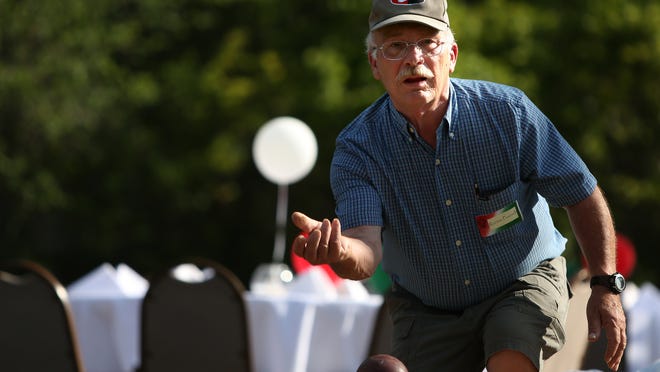 Ron Povinelli throws his ball during a bocce match between the Italian Heritage Association and the Highland Golf and Country Club at the Highland Golf and Country Club in Indianapolis on Friday, July 11, 2014.