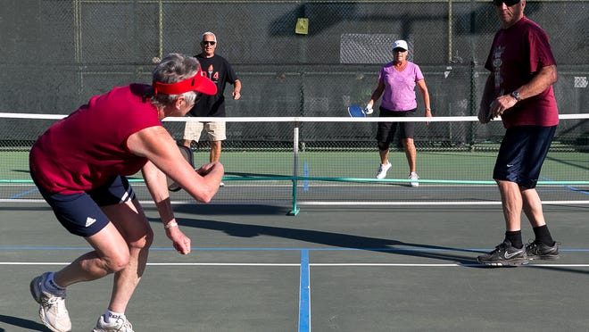Judy Van Aert, left, is unable to return the ball during a mixed doubles pickleball game for ages 65-69 at the 14th annual Palm Desert Senior Games and International Sports Festival held at Palm Desert Civic Center Park.