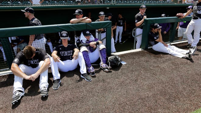 Tennessee Tech players watch from their dugout as Texas celebrates its win in the NCAA Super Regional on Monday.