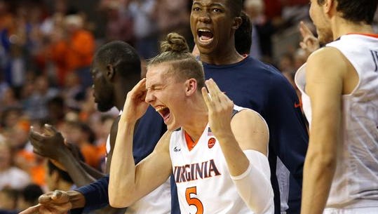 Virginia guard Kyle Guy (5) celebrates o the bench against the Ohio State Buckeyes in the second half at John Paul Jones Arena.