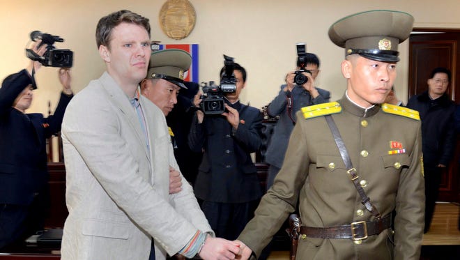 A photo provided by the official Korean Central News Agency (KCNA) shows U.S. student Otto Frederick Warmbier  with a security officer in Pyongyang, North Korea, 16 March 2016.