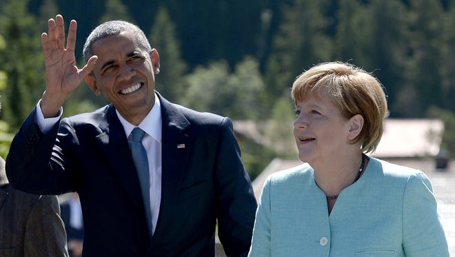 President  Obama waves as he is welcomed by German Chancellor Angela Merkel upon arrival at a breakfast meeting with local citizens in Kruen near Garmisch-Partenkirchen, southern Germany, on June 7, 2015 before the start of a G-7 summit.
