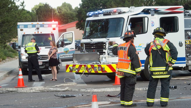 Responders work to clear a two-car accident Thursday, July 7, 2016. The crash caused delays on Lemay Avenue and shut down west-bound traffic on Drake Road. 