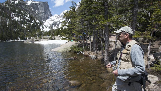 Pete Deal, visiting from West Virginia, uses a fly rod to target Greenback Cutthroat trout at Dream Lake in Rocky Mountain National Park. In addition to a park pass, Colorado residents and non-residents must purchase a fishing license to fish any water in the state.