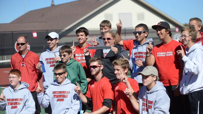 The Richmond boys tennis team celebrates after Logan Mayer's win at No. 2 singles gave the Red Devils their first ever semistate championship at Center Grove Saturday, Oct. 8, 2016.