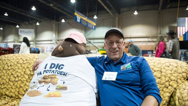 Jeff Klinger, an employee at Sterman Masser Potato Farm, poses with a couch potato at the Pennsylvania Farm Show on Friday. Klinger spent the day talking with visitors about the various uses of locally grown potatos. 