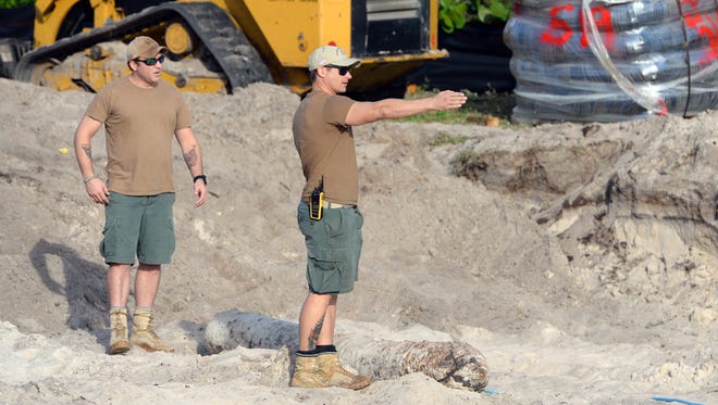 Members of a specialized Navy bomb disposal unit out of Jacksonville decide the best course of action Wednesday, Jan. 18, 2017, to get a World War II-era torpedo found in the Ocean Ridge subdivision south of Vero Beach to the water. The bomb was found Monday while a construction crew was working on a new home site. The team took the bomb out to sea, submerged and detonated the explosive.