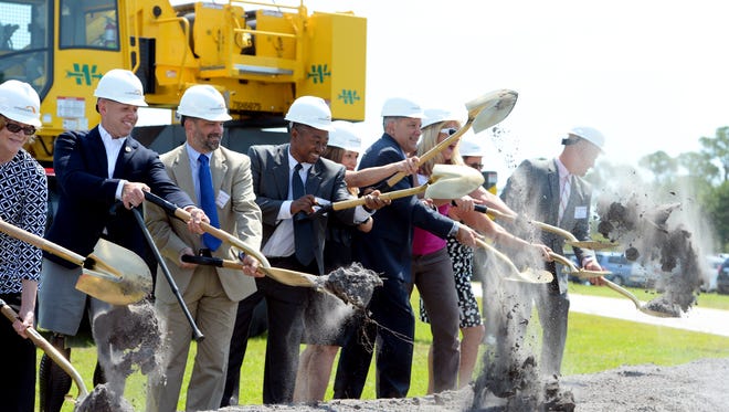 Federal, state and city employees shovel the first mounds of dirt May 9, 2017, during a groundbreaking ceremony for the Crosstown Parkway Extension Project in Port St. Lucie. The entire project, including acquisition of homes and property in the roadway's path, is expected to cost about $313.8 million.