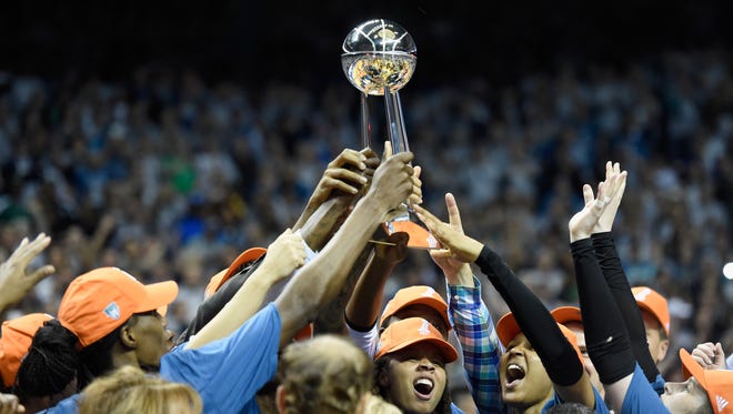 The Minnesota Lynx raise the Championship trophy after defeating the Los Angeles Sparks for the WNBA championship.