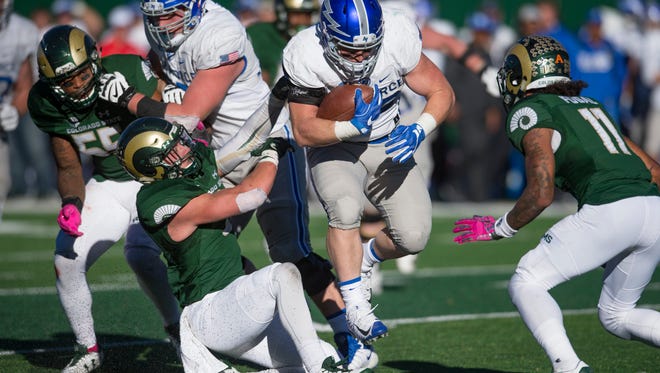 Air Force's Jacob Stafford runs through the CSU defense Saturday during the Falcons' 45-28 win over the Rams at Colorado State University Stadium.