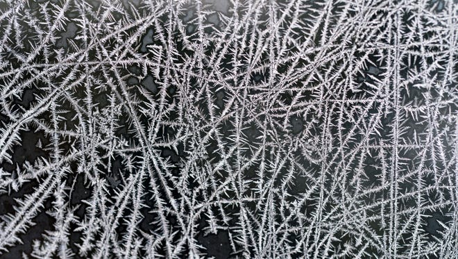 Frost patterns form on the window of a St. Joseph, Mich., home Tuesday, Jan. 2, 2018, after a night of sub-zero temperatures.  Bone-chilling cold gripped much of the U.S. as 2018 began, breaking century-old records and leading to several deaths that authorities attributed to exposure to the dangerously low temperatures.]