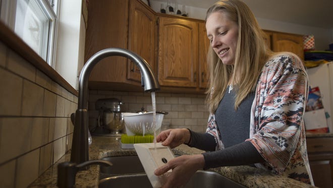 Danielle Juchartz washes dishes after lunchtime at her home near Horsetooth Reservoir on Thursday, January 25, 2018. The Juchartz family and their neighbors, serviced by the Spring Canyon water district, are paying among the highest water utility rates in the country.