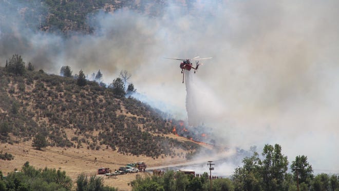 Crews drop water on a section of the Klamathon Fire burning near the California-Oregon border.