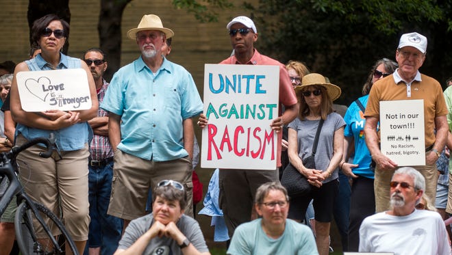 Crowd members hold signs speaking out against racism and hate during the Kindness Rally in Krutch Park in downtown Knoxville on Aug. 26, 2017.
