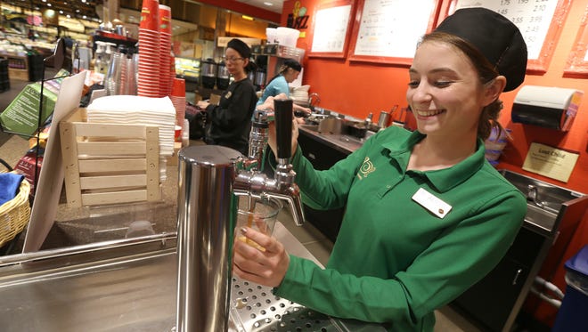 Alicia Chapman, Coffee Team Leader, pours a cup of Nitro Cold Brew Coffee from a tap system at the East Avenue Wegmans in Rocheser Thursday, June 2, 2016. 