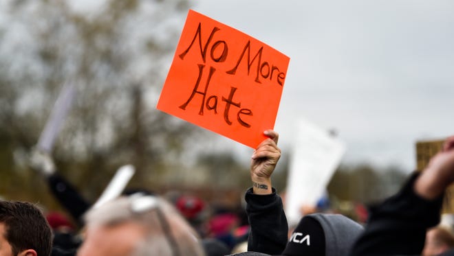 Counterprotesters hold signs during a White Lives Matter rally in Shelbyville, Tenn., Saturday, Oct. 28, 2017.