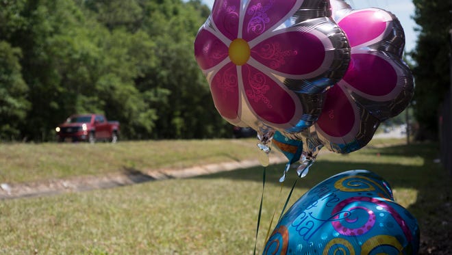 A makeshift memorial can be seen Monday, May 7, 2018, on Woodbine Road in Pace, where a suspected drunken driver crashed into a vehicle and killed two sisters.