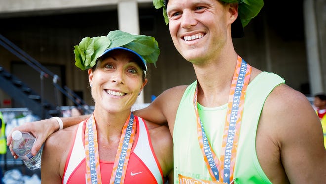 Two-time defending Flying Pig Marathon winner Amy Robillard (left) won the women's half-marathon (1:22:40) Sunday while David Bea was the top overall half finisher in 1:14:18.