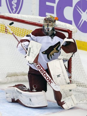 Arizona Coyotes goalie Mike Smith deflects a Minnesota Wild shot during the third period of an NHL hockey game, Thursday, Oct. 23, 2014, in St. Paul, Minn. The Wild won 2-0.