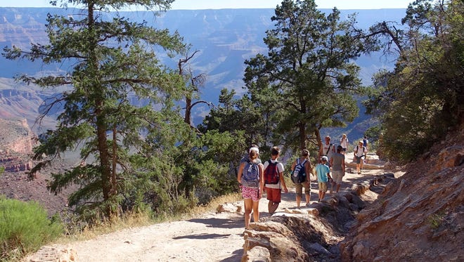 Hikers cross paths along Bright Angel Trail heading into and out of the Grand Canyon at Grand Canyon National Park, Ariz., on July 27, 2016.