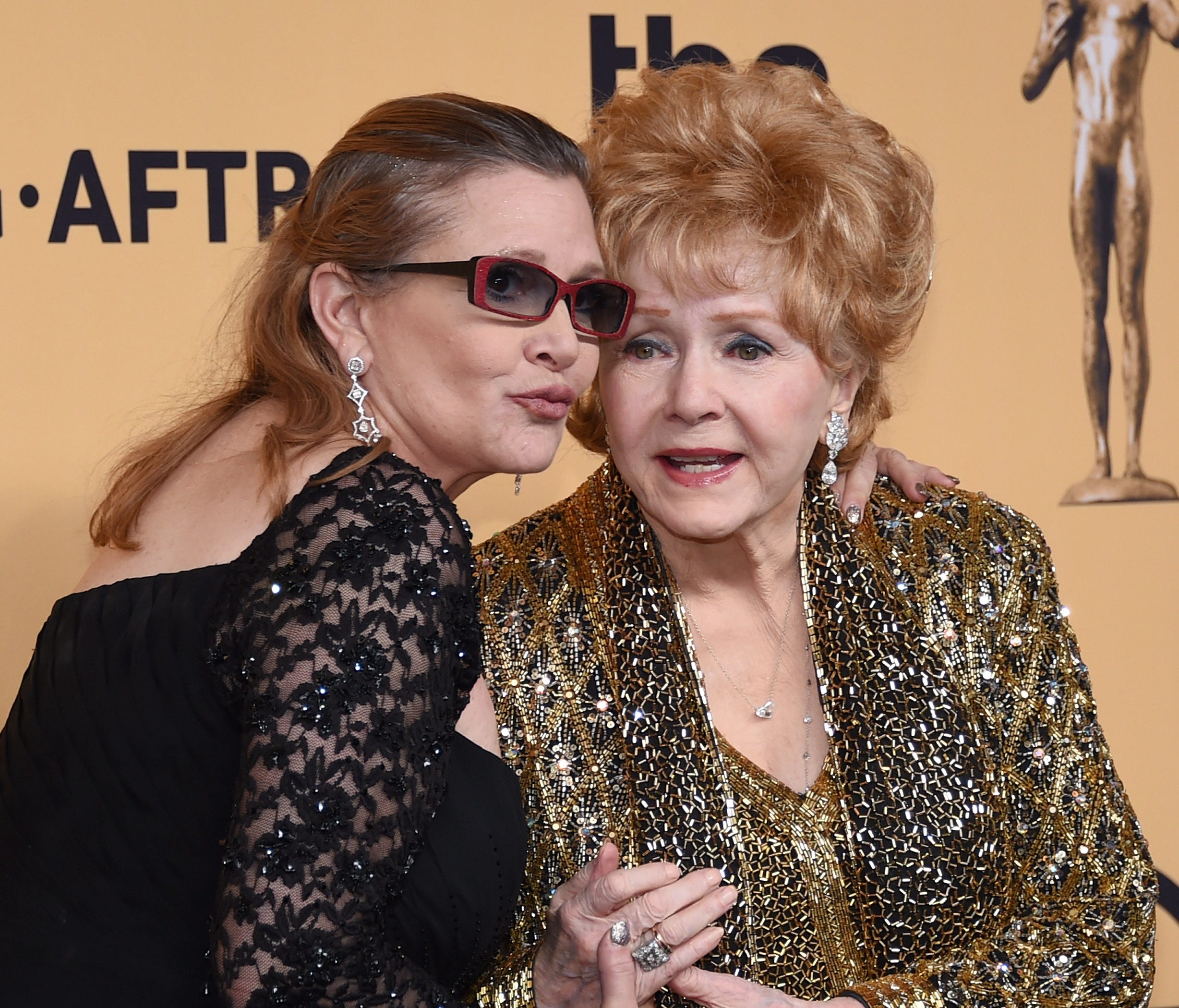 Debbie Reynolds, shown here with her late daughter Carrie Fisher,  was rushed to a Los Angeles area hospital Wednesday.
