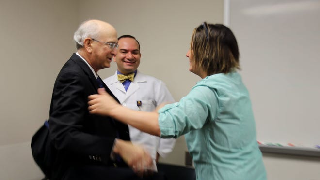 Samantha Carlson, 29, of Saline meets Dr. Robert Forte, 64, of Farmington Hills for the first time as his physician Dr. Ankit Sakhuja looks on.
