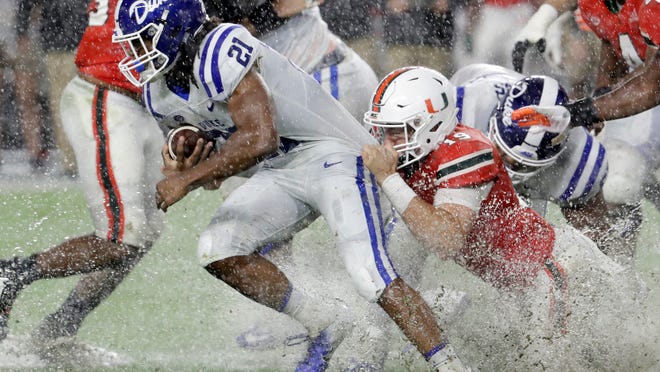 Miami defensive lineman Scott Patchan (19) attempts to tackle Duke running back Mataeo Durant (21) during the first half of an NCAA college football game Saturday, Nov. 3, 2018, in Miami Gardens, Fla. (AP Photo/Lynne Sladky)