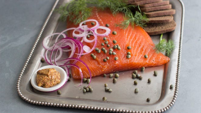 Gravlax , as cured salmon is known by its Nordic name, generally is made by dry-curing fillets of salmon in a blend of sugar, kosher salt, fresh dill and a variety of other seasonings.