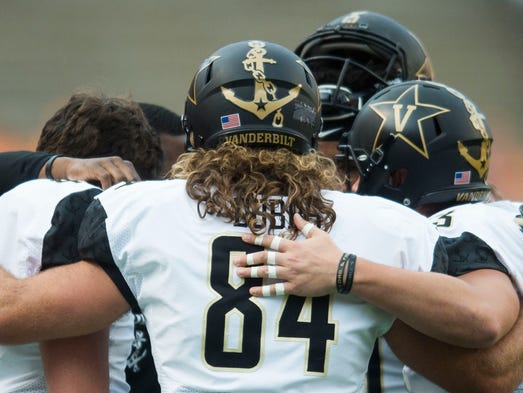 Vanderbilt players huddle before a game between Tennessee