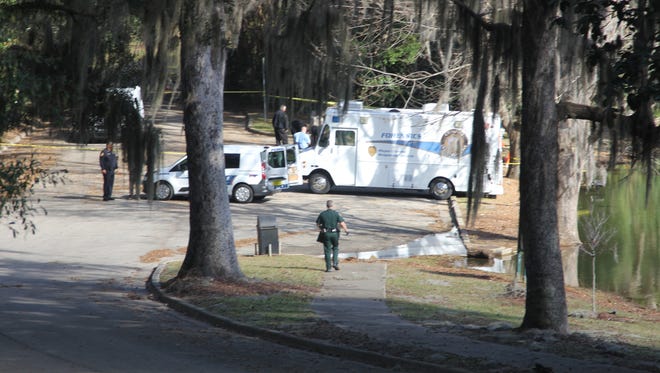 Tallahassee Police Department investigators combed the rim of Chapman Pond in Myers Park, where a man's body was found Wednesday morning.