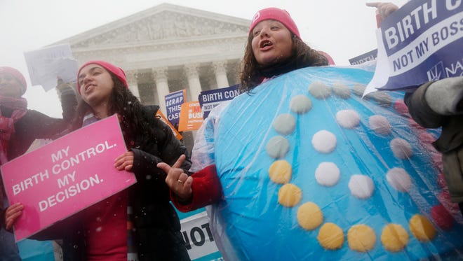 FILE - In this March 25, 2015, file photo, Margot Riphagen, of New Orleans, wears a birth control pills costume as she protests in front of the Supreme Court in Washington, as the court heard oral arguments in the challenges of President Barack Obama's health care law requirement that businesses provide their female employees with health insurance that includes access to contraceptives. Some insurance plans offered on the health marketplaces violate the law’s requirements for women’s health, according to a new report from a women’s legal advocacy group. The National Women’s Law Center analyzed plans in 15 states over two years and found some excluded dependents from maternity coverage, prohibited coverage of breast pumps or failed to cover all federally approved birth control methods. (AP Photo/Charles Dharapak, File)