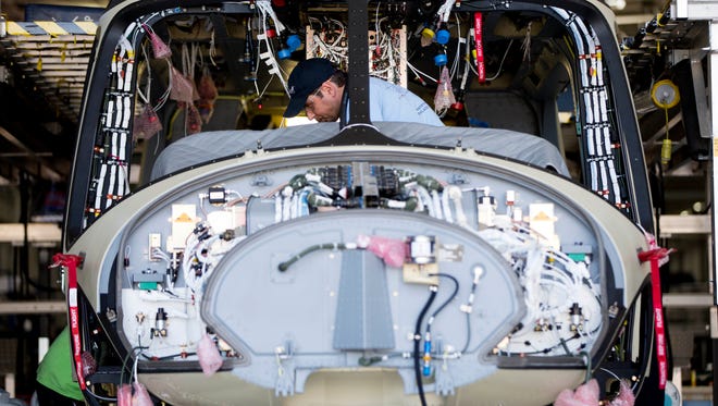 A worker helps to assemble a helicopter at AgustaWestland's aircraft manufacturing facility in Philadelphia.
