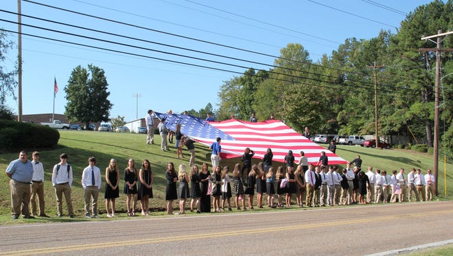 Jackson Christian students line up to pay their respects as a procession for Deputy Rosemary Vela's funeral passes by on Thursday morning.