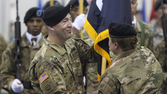 Command Sgt. Maj. Michael J. Perry, incoming  CSM for the 101st Sustainment Brigade, receives the guidon from Col. Kimberly J. Daub on Friday at Fort Campbell.