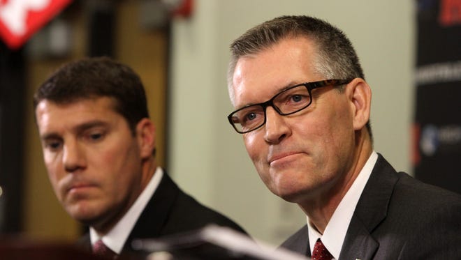 (not pictured) Rutgers University President Robert Barchi and (center) Rutgers University Director of Athletic Patrick Hobbs announce (left) Chris Ash has been named head coach of the Rutgers University Scarlet Knights football program during a press conference in the Hale Center at Rutgers University in Piscataway, NJ Monday December 7, 2015.