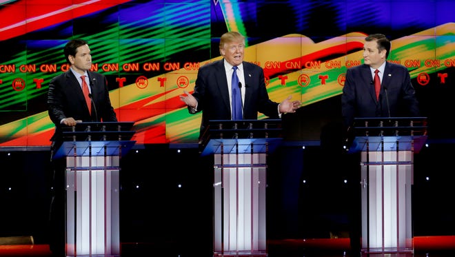 Republican presidential candidate Donald Trump speaks as U.S. Sens. Marco Rubio, R-Florida, left, and Ted Cruz, R-Texas, look on during a Republican presidential primary debate at The University of Houston, Thursday.