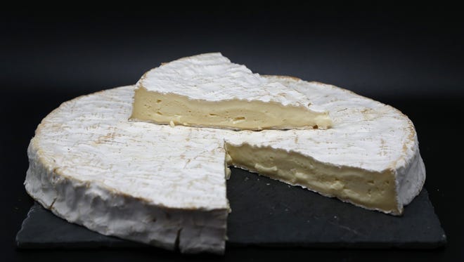 A block of brie, a popular French soft cheese.
