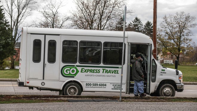 Kevin Johnson boards the Plainfield Connector shuttle service, at Bridgeport Road, between Washington Street and Perimeter Road, Wednesday November 18th, 2015. 
The shuttle service connects IndyGo riders on the No. 8 Washington Street line with their jobs in the industrial parks in Plainfield.