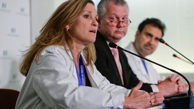 Dr. Ihor Sawczuk, president of the Hackensack University Medical Center, center, and Dr. Abdulla Al-Khan, director of the Center for Abnormal Placentation, right, watch as Dr. Julia Piwoz, chief of the Pediatric Infections Diseases at the Joseph M. Sanzari Children's Hospital speaks during a news conference at the Hackensack University Medical Center Wednesday in Hackensack. Doctors say a baby born to a mother with the Zika virus appears to be affected by the disease.