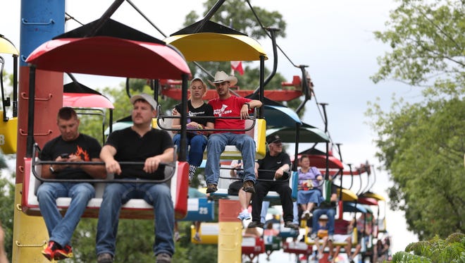 Fairgoers ride the Sky Glider on Saturday, Aug. 16, 2014, at the Iowa State Fair in Des Moines, Iowa.