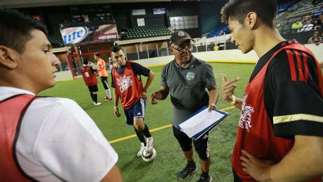 Players talk with El Paso Coyotes coach on the first day of tryouts Thursday at the El Paso County Coliseum.