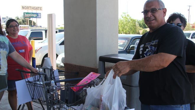 Mike Campos is one of several resident who donated to United Way's Stuff the Bus campaign Friday. The campaign collects several school supplies for the upcoming school year.