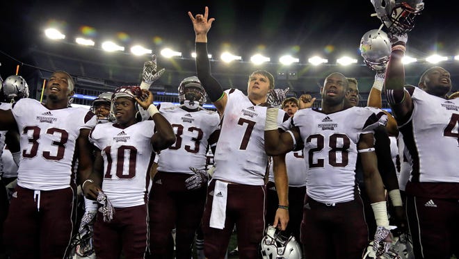Mississippi State quarterback Nick Fitzgerald (7) and teammates celebrate with fans after the win against UMass on Saturday.