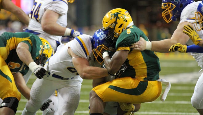 South Dakota State's Christian Banasiak (69) lays a hit on North Dakota State's Bruce Anderson (8) during the second quarter of the Jacks' 19-17 victory over the Bison to win the Dakota Marker Saturday afternoon at the Fargodome in Fargo, ND.