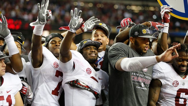Alabama players celebrate victory against Florida after the Southeastern Conference championship NCAA college football game, Saturday, Dec. 3, 2016, in Atlanta. Alabama won 54-16. The Crimson Tide will face Washington in a College Football Playoff Semifinal on Dec. 31.