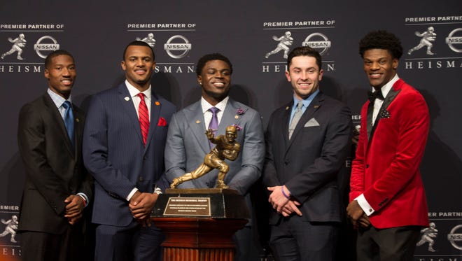 Heisman Trophy finalists pose with the famokus trophy prior to the winner being announced. From left to right, Dede Westbrook, Oklahoma, Deshaun Watson, Clemson, Jabrill Peppers, Michigan, Baker Mayfield, Oklahoma and Lamar Jackson, Louisville. Dec. 10, 2016