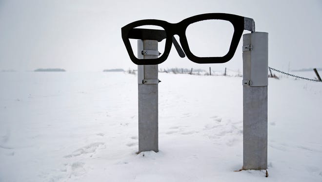 A monument depicting musician Buddy Holly's glasses stands at the edge of a snowy field near the spot where the plane carrying Holly, Ritchie Valens and J.P. "The Big Bopper" Richardson crashed near Clear Lake, Iowa, Friday, Jan. 8, 2016. The three performers died in a plane crash Feb 3, 1959, after their final performance in Clear Lake.