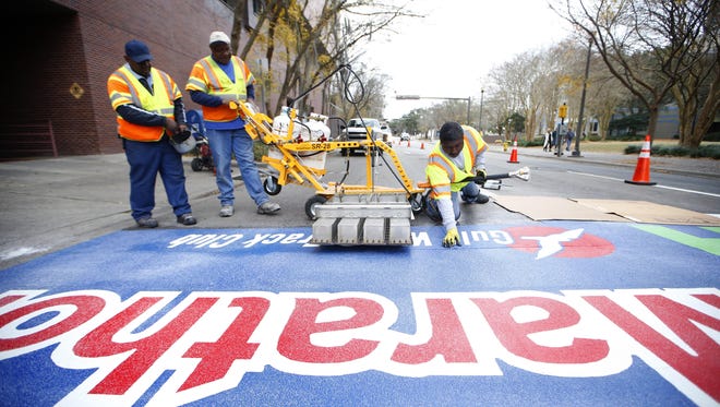 Joe Rondone/Democrat
Workers put the finishing touches on a permanent finish line in advance of the 2016 Tallahassee Marathon.
.