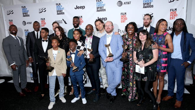 Filmmaker Barry Jenkins and cast and crew of 'Moonlight' pose after winning several Spirit Awards.